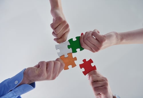 Group of business people assembling jigsaw puzzle and represent team support and help concept Group of business people assembling jigsaw puzzle and represent team support and help concept