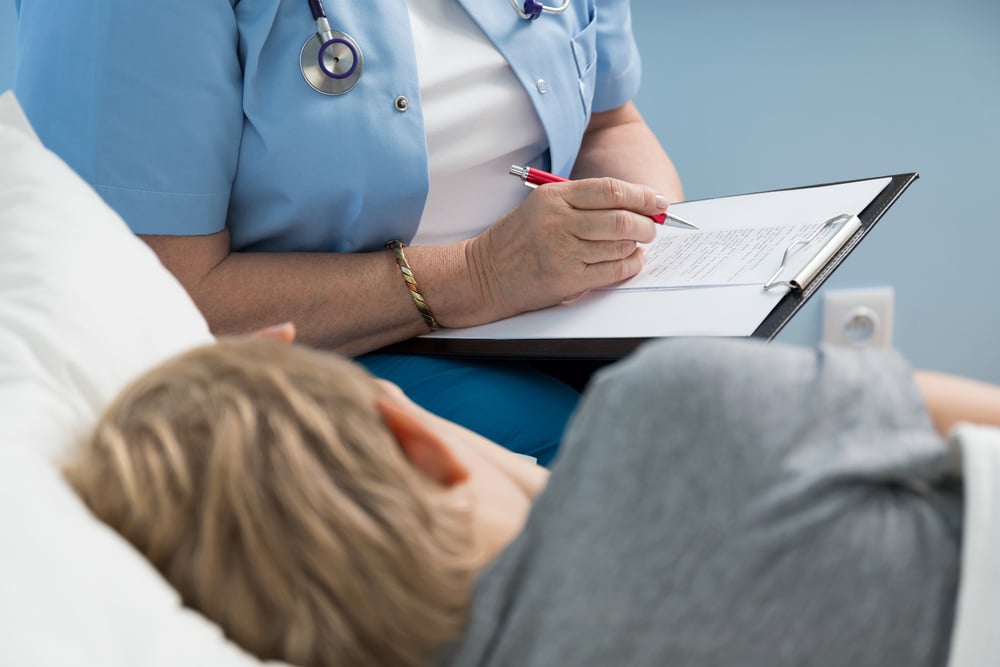 Female doctor writing down her notes about little kids condition